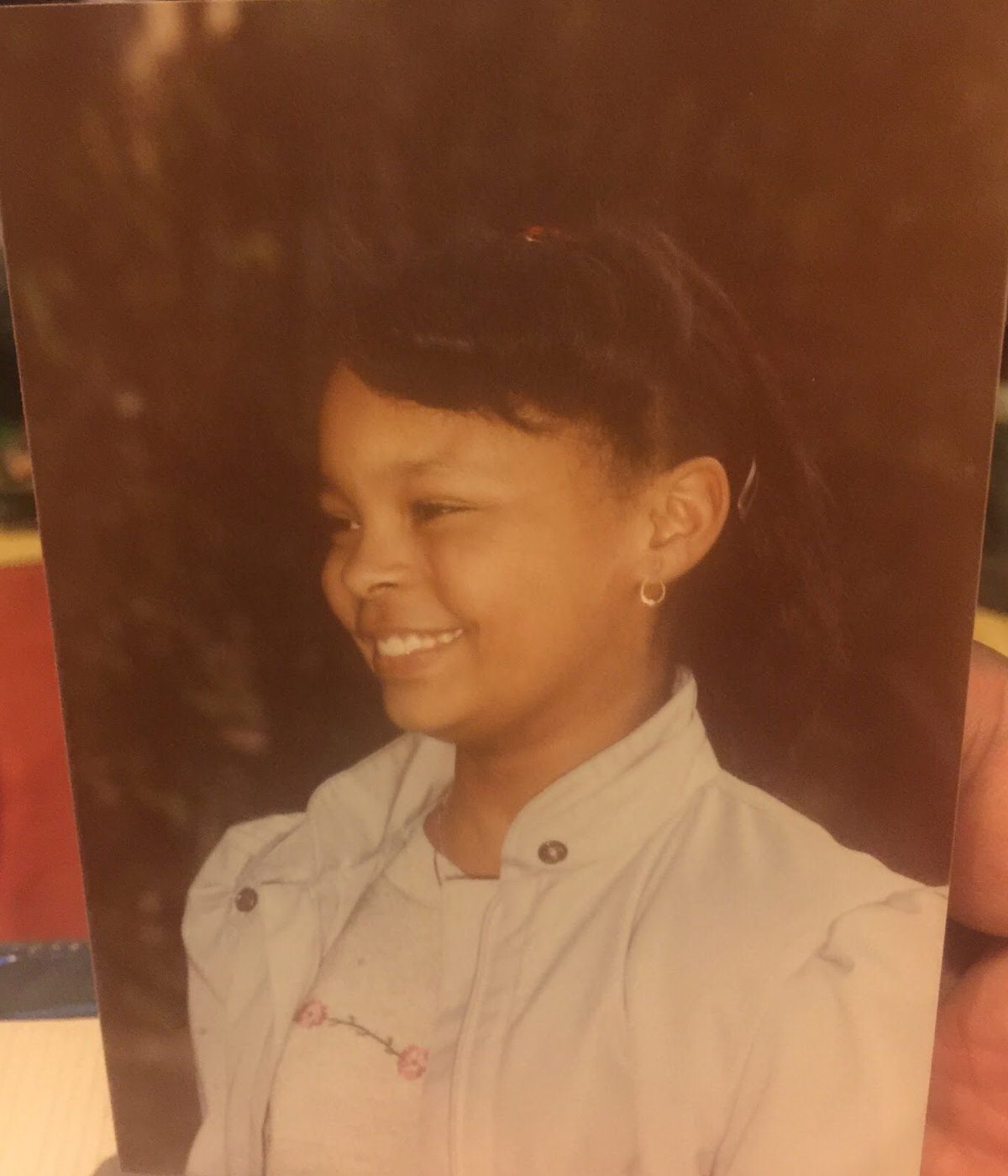 Sonya as a young girl, smiling in profile