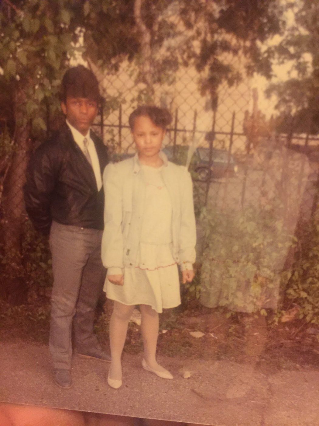 Sonya dressed up outdoors, standing beside a young man
