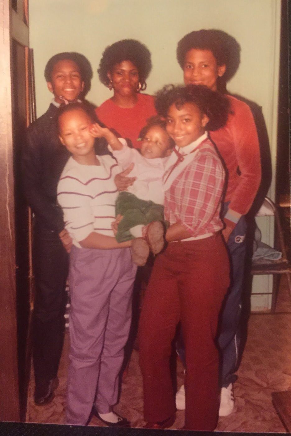 Sonya with family, gathered together in a doorway
