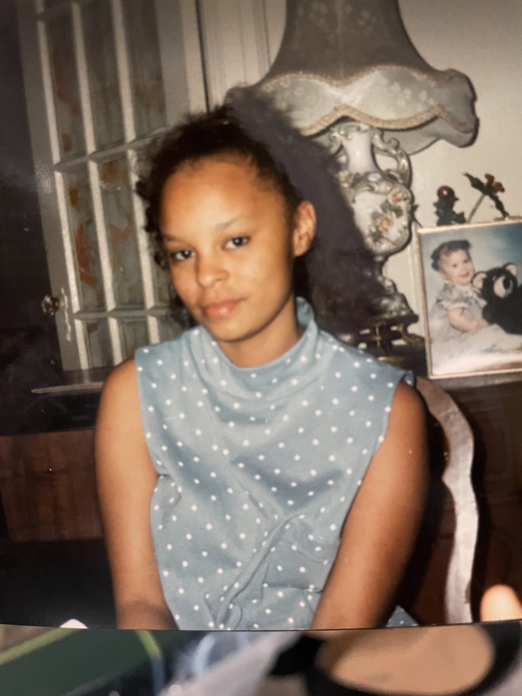 Sonya in a blue polka-dot top at home