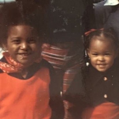 Sonya as a toddler, smiling beside another child